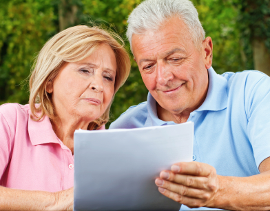Two seniors looking over retirement information.